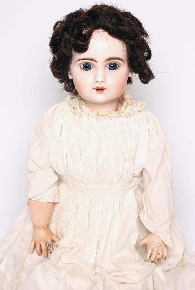 A Bebe Jumeau bisque head doll with fixed blue glass paperweight eyes Image