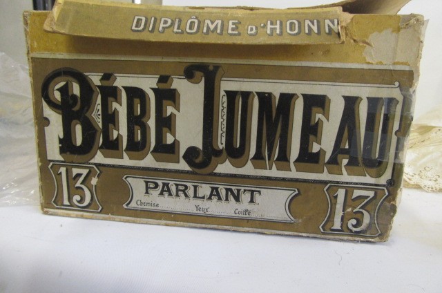 A Bebe Jumeau bisque head doll with fixed blue glass paperweight eyes Image