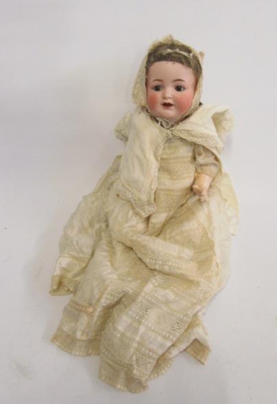A Kammer & Reinhardt bisque head character doll with brown glass flirty eyes Image