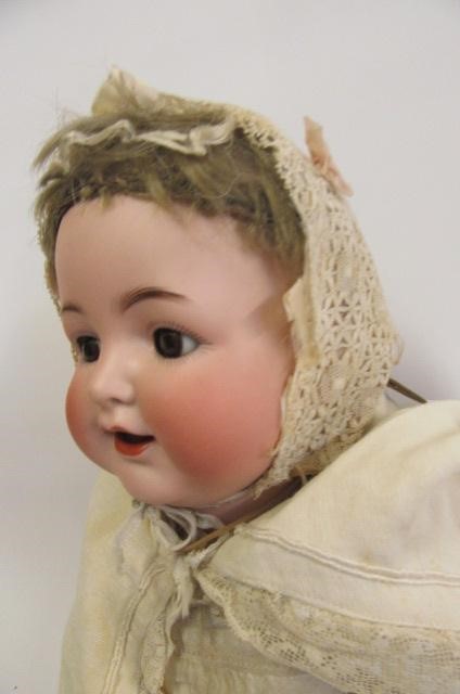 A Kammer & Reinhardt bisque head character doll with brown glass flirty eyes Image