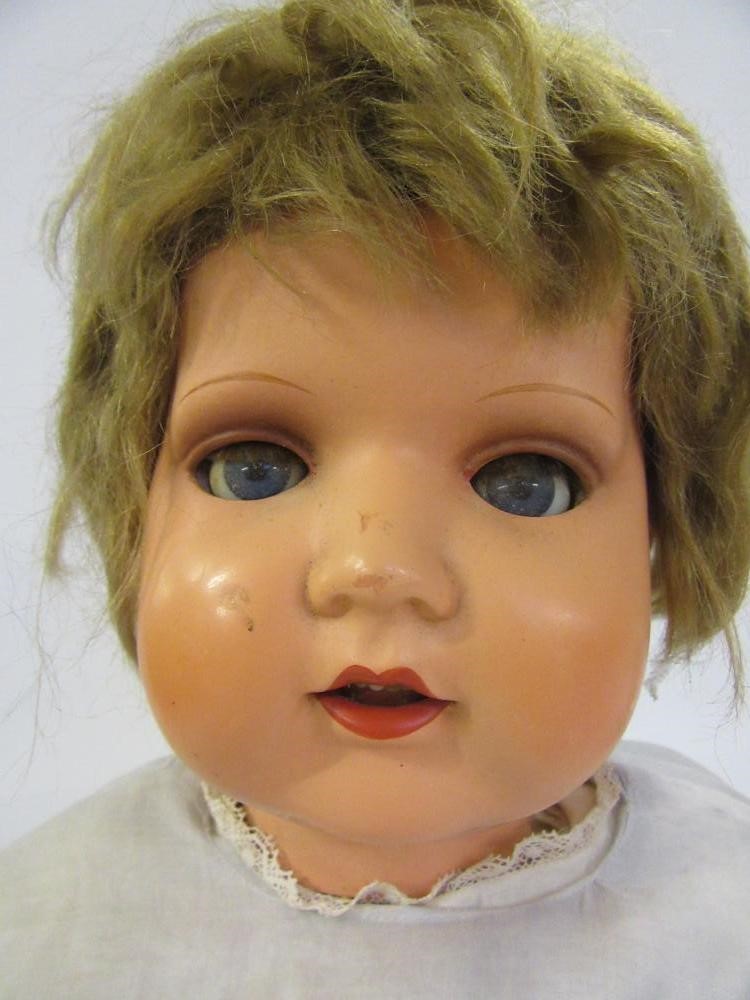 A mid 20th century German composition walking doll with blue glass sleeping eyes Image
