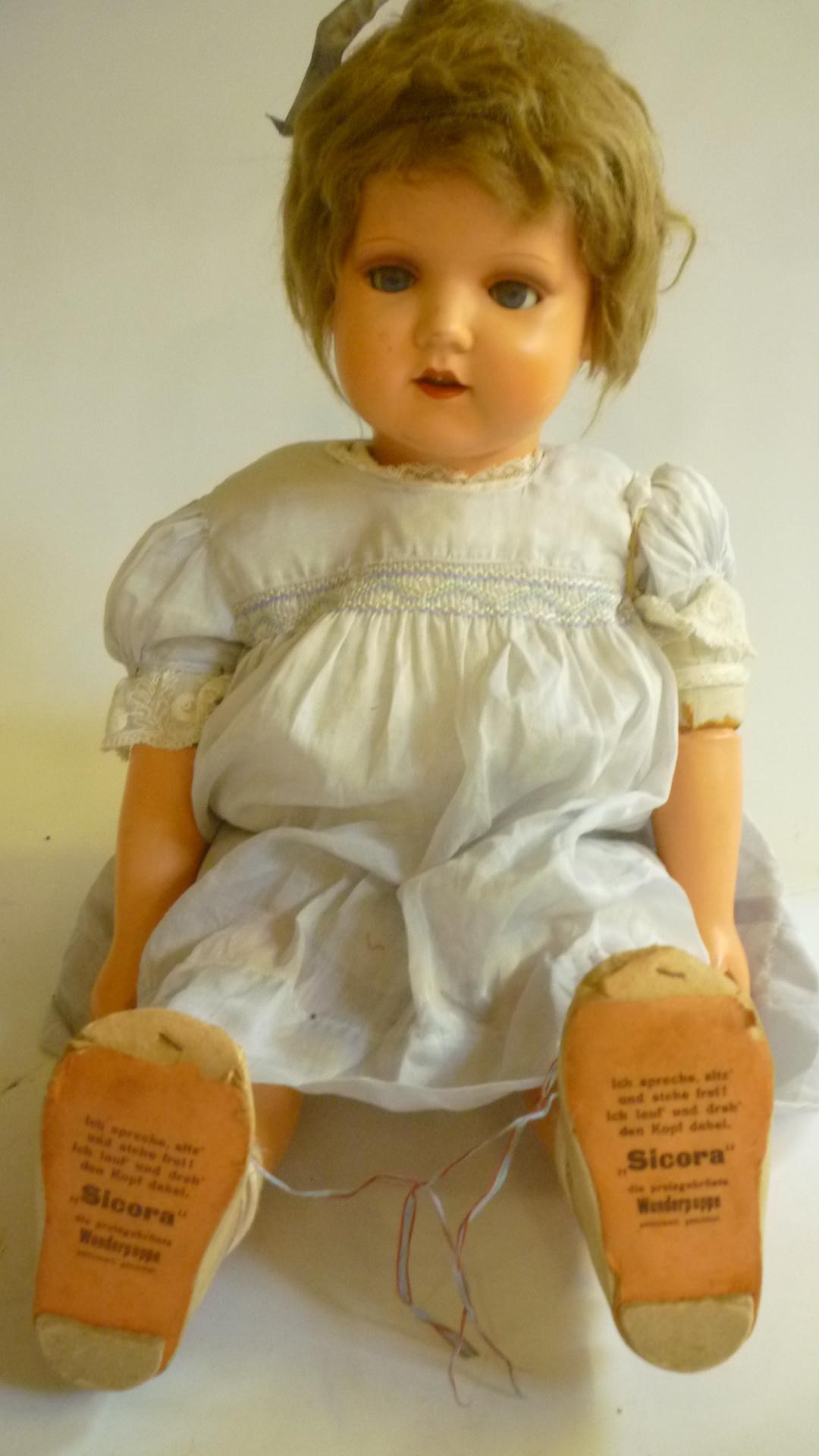 A mid 20th century German composition walking doll with blue glass sleeping eyes Image