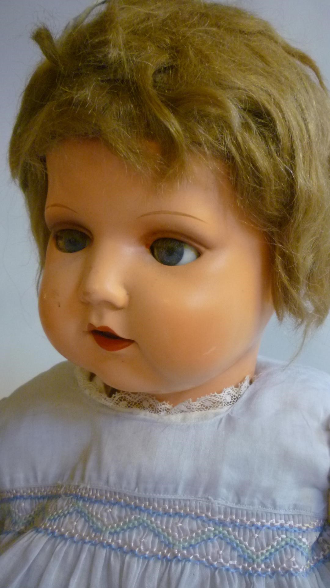 A mid 20th century German composition walking doll with blue glass sleeping eyes Image