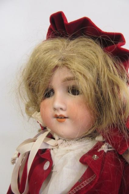 An Armand Marseille bisque head doll with brown glass sleeping eyes Image