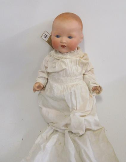 An Armand Marseille bisque head baby doll with intense blue glass sleeping eyes Image