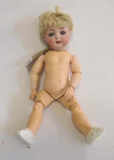 A Kammer & Reinhardt bisque head doll with blue glass sleeping eyes Image