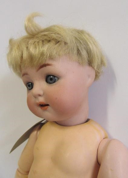 A Kammer & Reinhardt bisque head doll with blue glass sleeping eyes Image