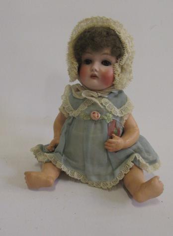 An Armand Marseille bisque head doll with brown glass sleeping eyes Image