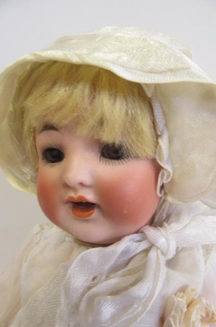 A Kammer & Reinhardt bisque head character doll with brown glass sleeping eyes Image