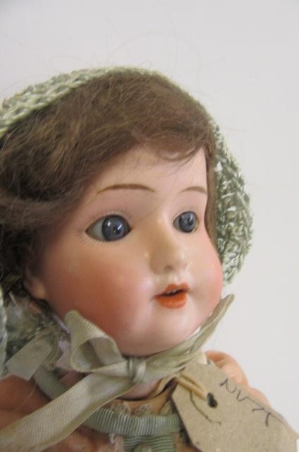 A Schoenau & Hoffmeister bisque head doll with fixed blue glass eyes Image