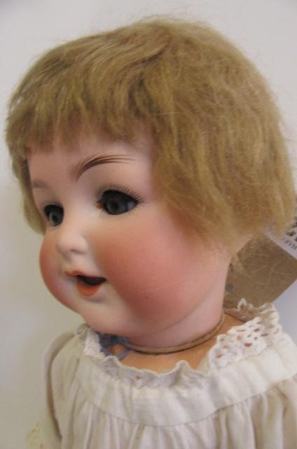 An Ernst Heubach bisque head character doll with blue glass sleeping eyes Image
