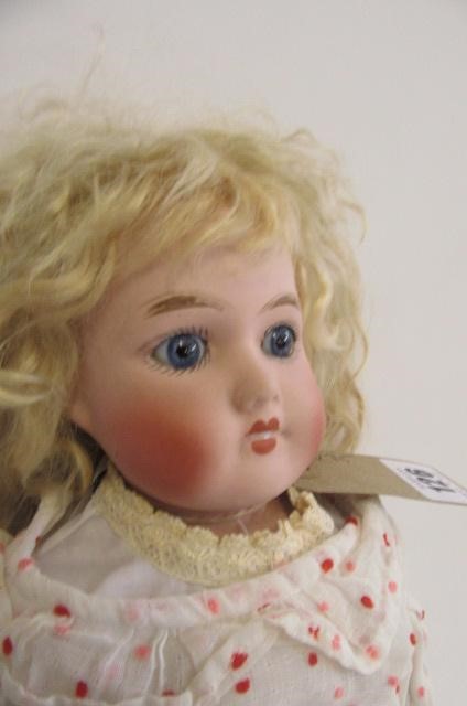 A DURA (English) bisque shoulder head doll with fixed blue glass eyes Image