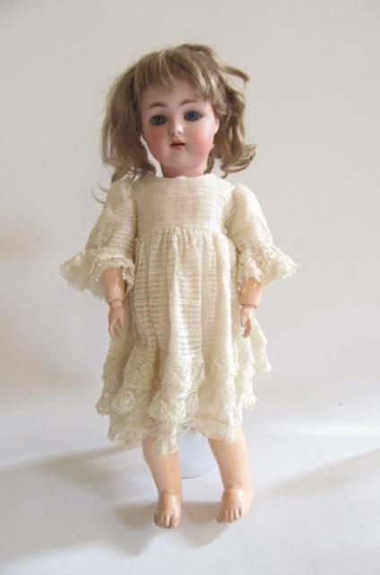 A Kammer & Rheinhardt bisque head doll with blue glass sleeping eyes Image