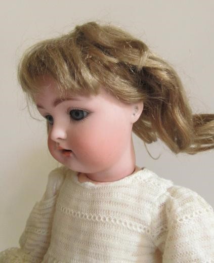 A Kammer & Rheinhardt bisque head doll with blue glass sleeping eyes Image