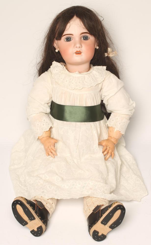 A Tete Jumeau bisque head doll with fixed blue paperweight glass eyes Image