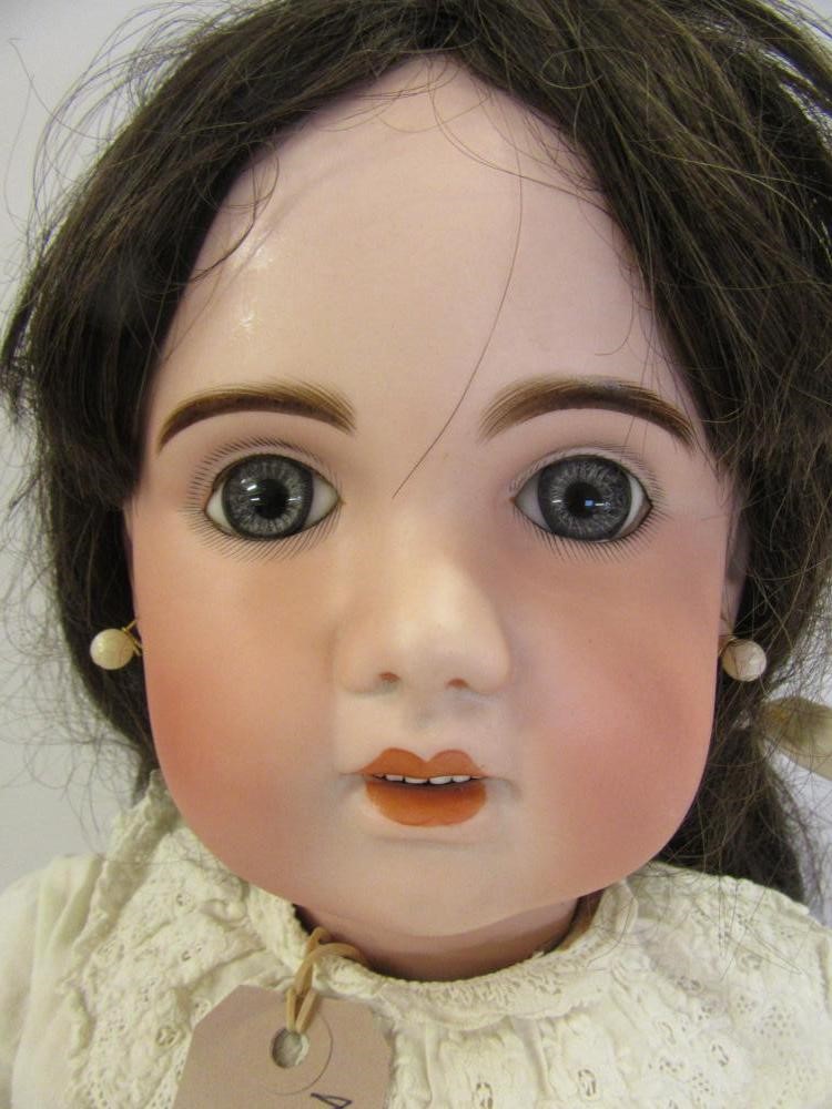 A Tete Jumeau bisque head doll with fixed blue paperweight glass eyes Image