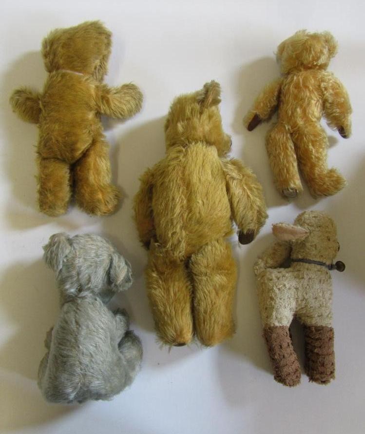 Three teddy bears covered in gold plush Image