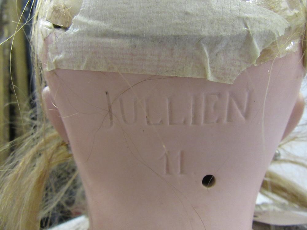 A French Bebe bisque head doll with fixed blue paperweight glass eyes Image