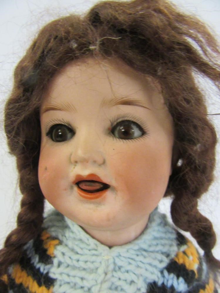 An Ernst Heubach bisque head doll with brown glass sleeping eyes Image