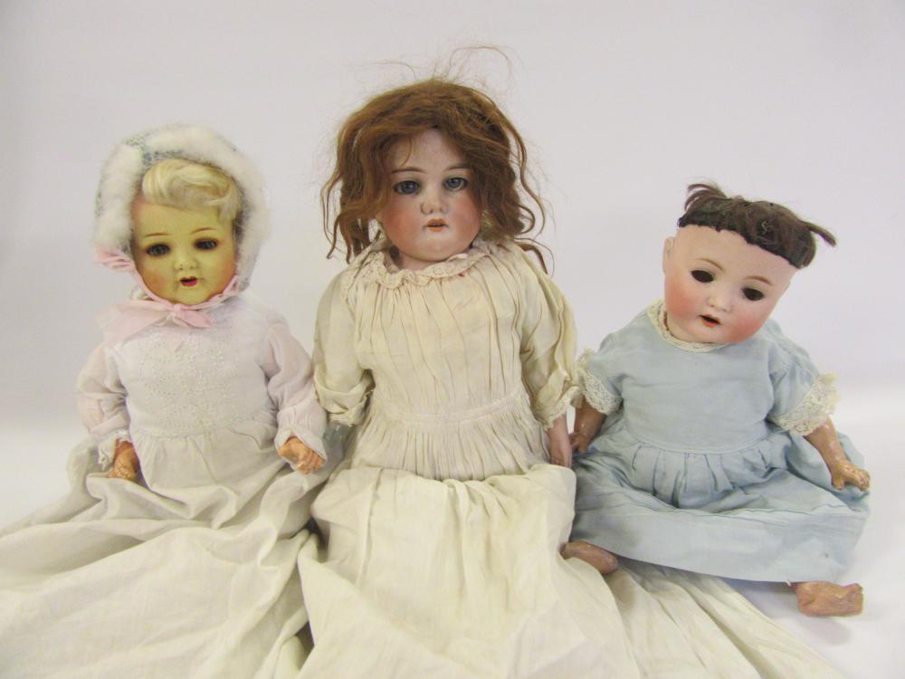 An Armand Marseille bisque shoulder head doll with blue glass sleeping eyes Image