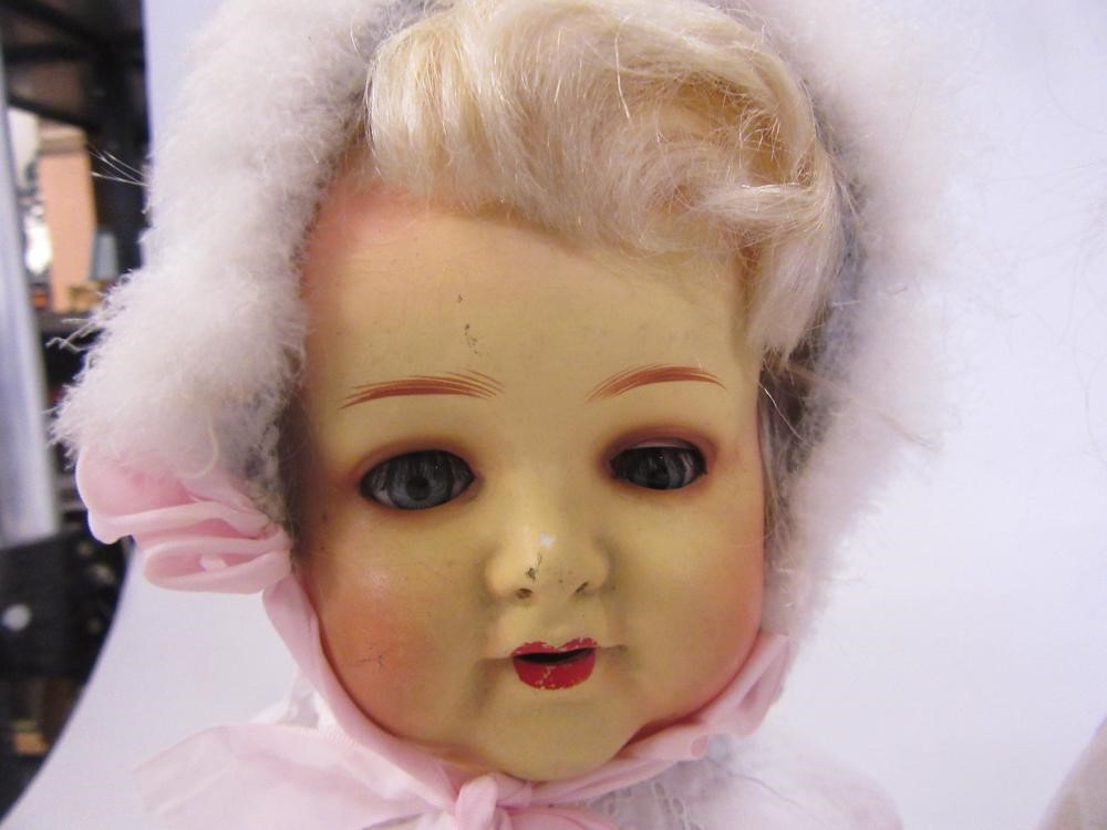 An Armand Marseille bisque shoulder head doll with blue glass sleeping eyes Image