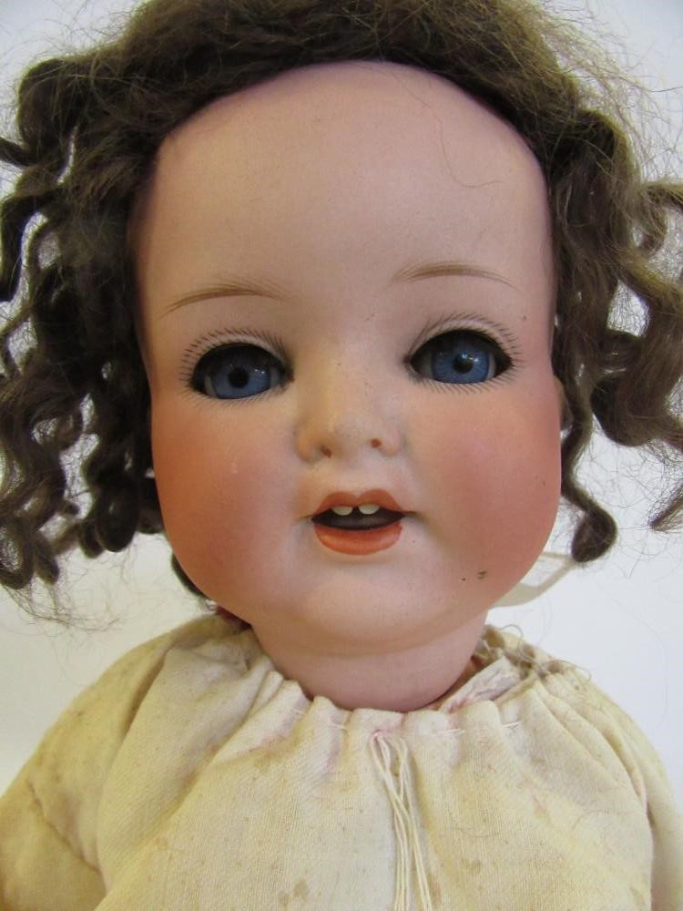 An Armand Marseille bisque head doll with blue glass sleeping eyes Image