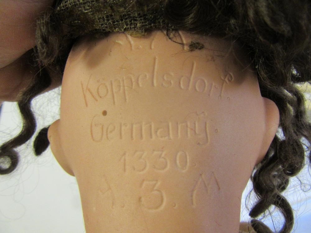 An Armand Marseille bisque head doll with blue glass sleeping eyes Image