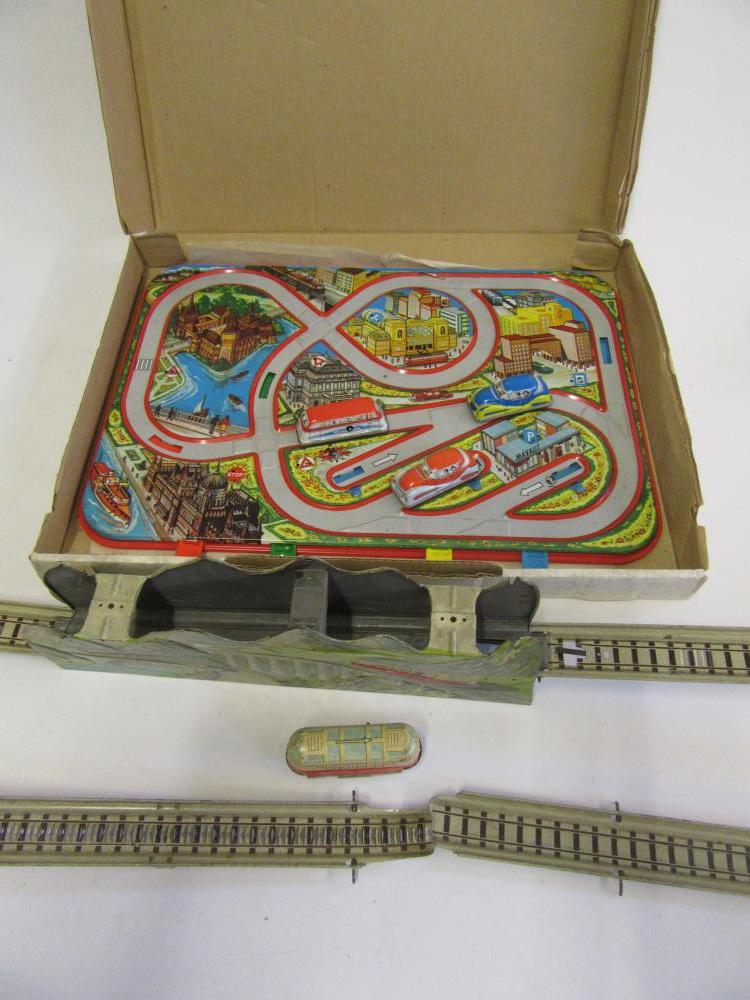 Two tinplate track toys comprising an Alpine railway and a road safety track (Est. plus 21% premium Image