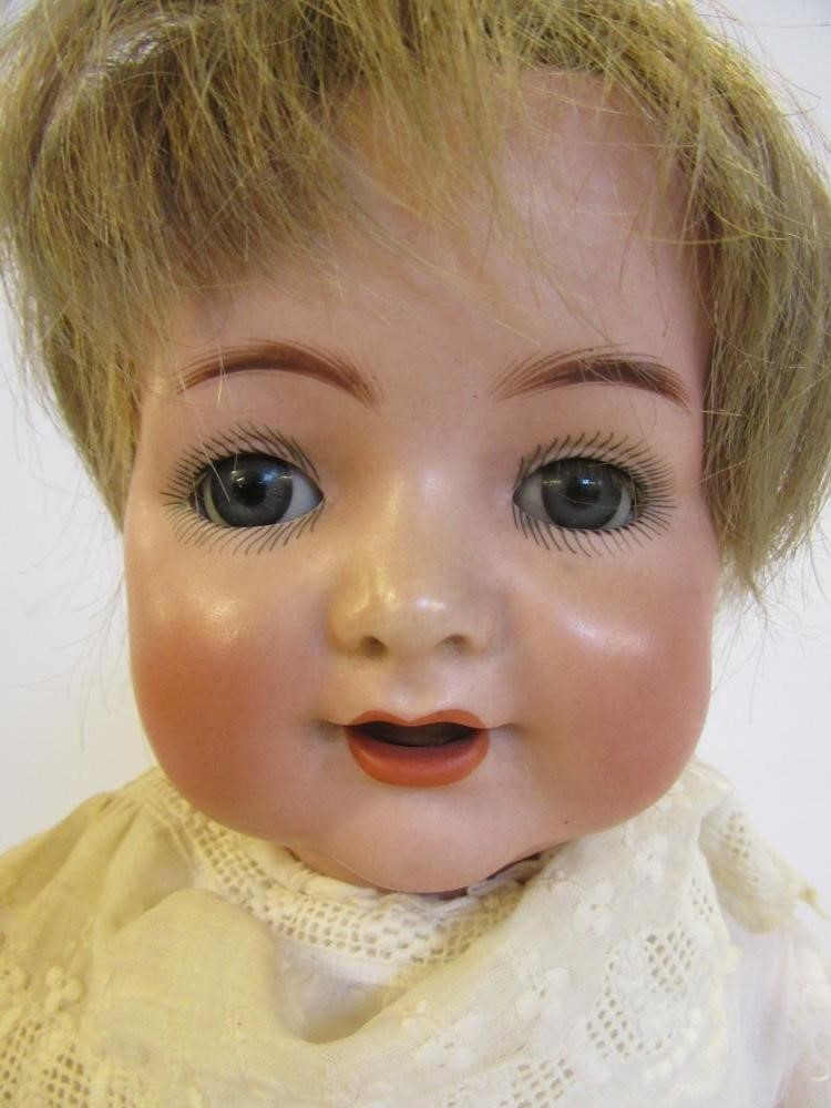 A Kammer & Reinhardt bisque head character doll with blue glass sleeping eyes Image