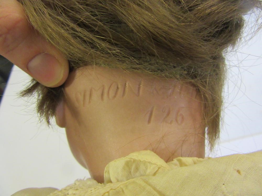 A Kammer & Reinhardt bisque head character doll with blue glass sleeping eyes Image