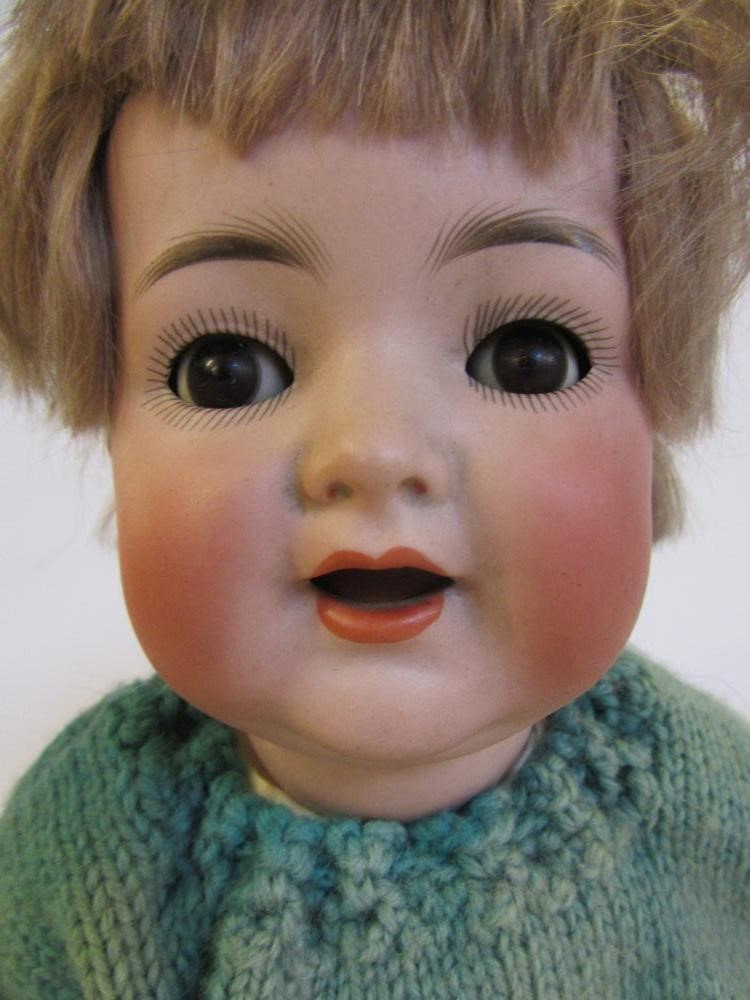 A Kammer & Reinhardt bisque head character doll with brown glass flirty eyes Image