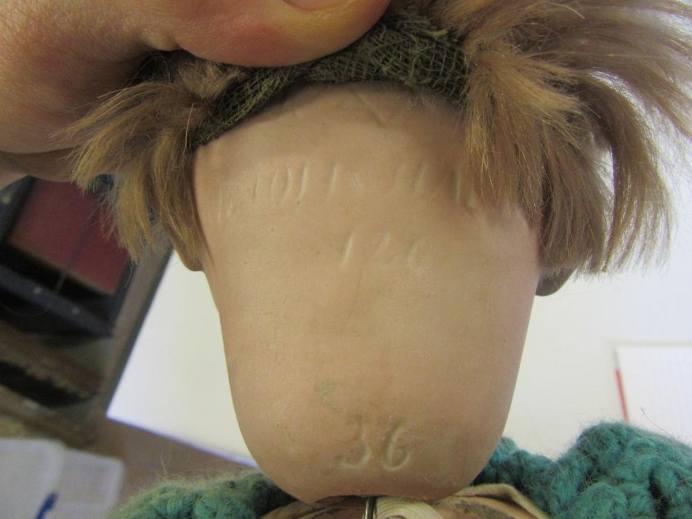 A Kammer & Reinhardt bisque head character doll with brown glass flirty eyes Image