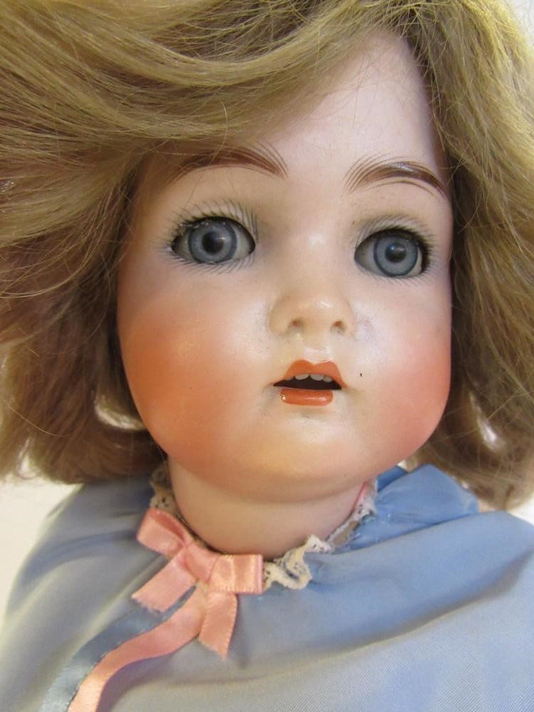 A Kammer & Reinhardt bisque head doll with blue glass sleeping eyes Image