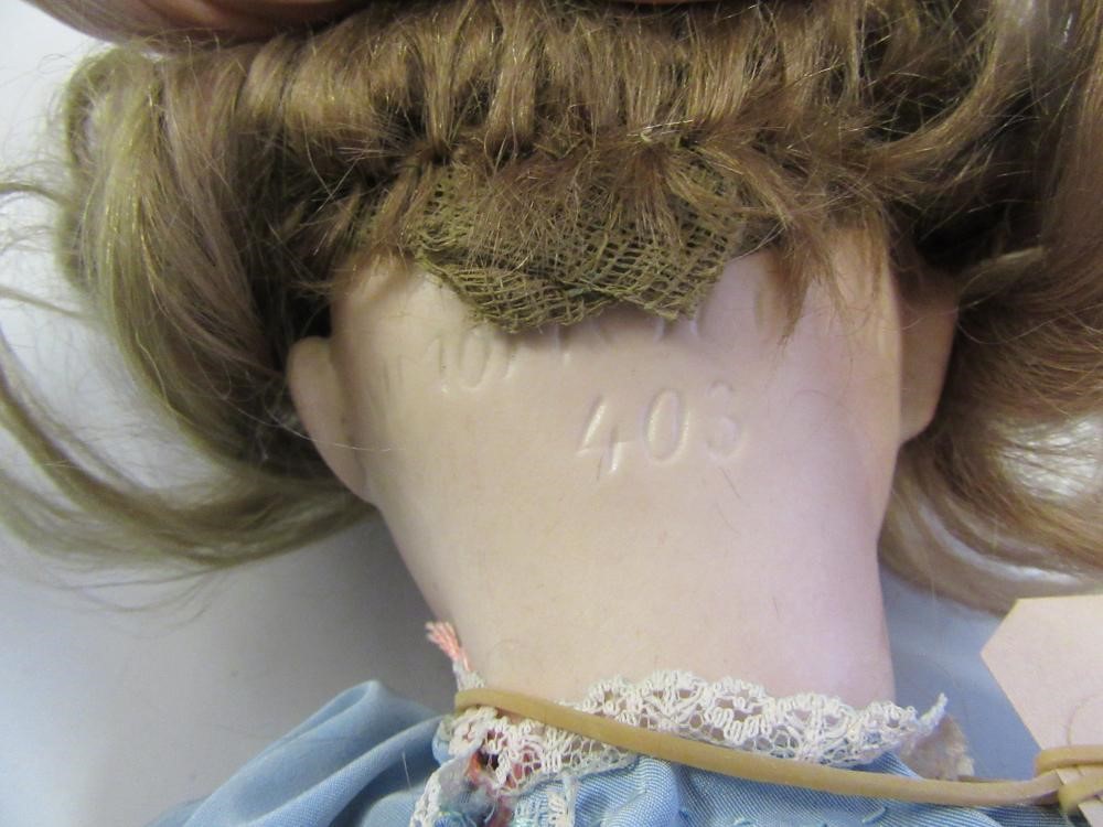 A Kammer & Reinhardt bisque head doll with blue glass sleeping eyes Image