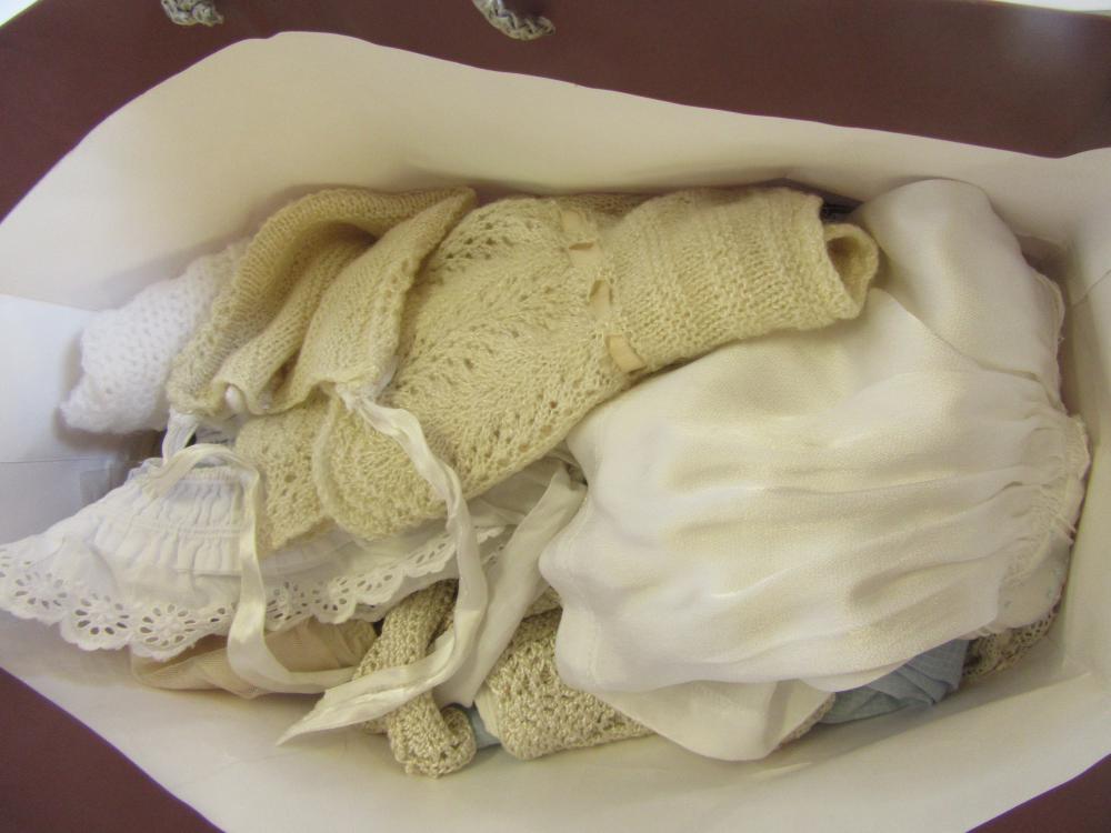 A quantity of dolls clothing in crochet Image