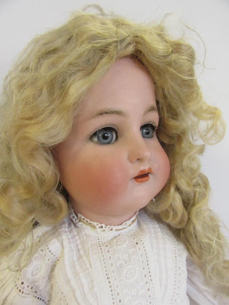 A Kammer & Reinhardt bisque head doll with blue glass sleeping eyes Image
