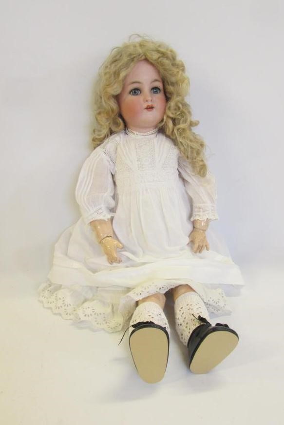 A Kammer & Reinhardt bisque head doll with blue glass sleeping eyes Image