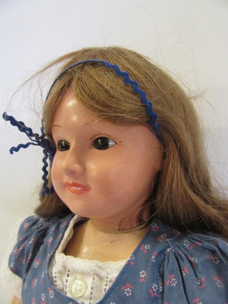 A French all composition doll with fixed brown glass eyes Image