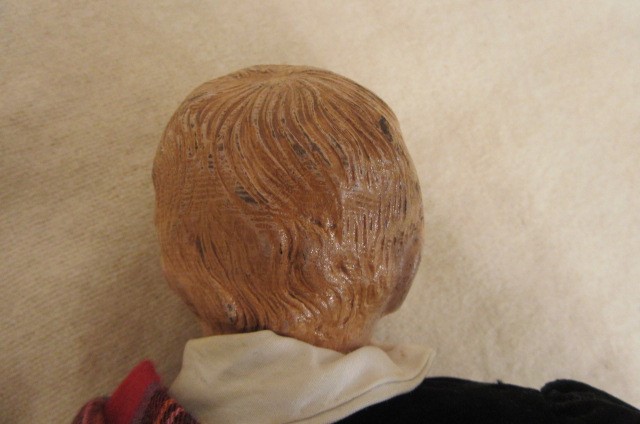 An Albert Schoenhut all wood boy doll with carved painted face and hair Image