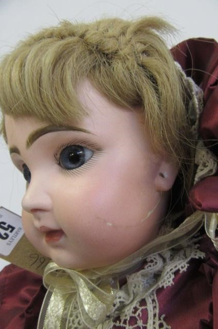 A Tete Jumeau bisque head doll with fixed blue glass eyes Image
