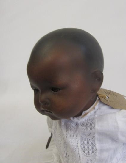 An Armand Marseille Mulatto baby doll with brown glass sleeping eyes Image