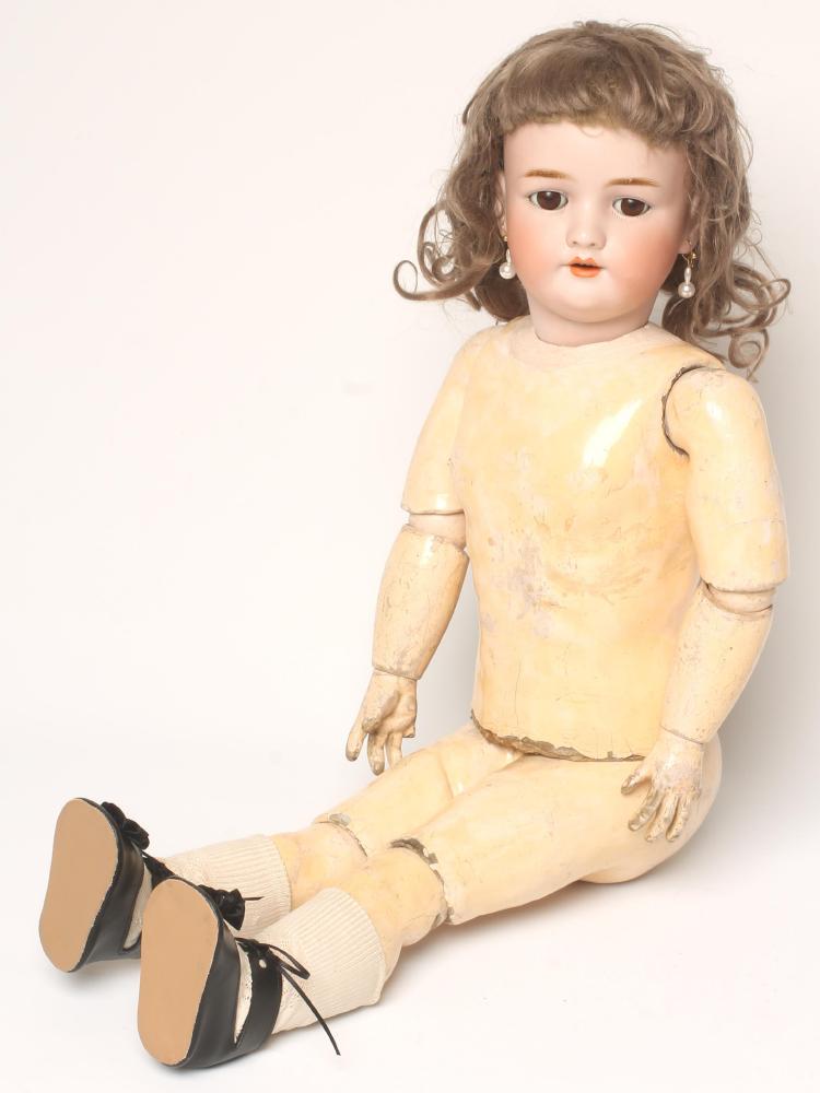 A Heinrich Handwerck bisque head doll with brown glass sleeping eyes Image