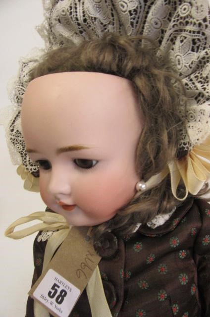 A Heinrich Handwerck bisque head doll with brown glass sleeping eyes Image