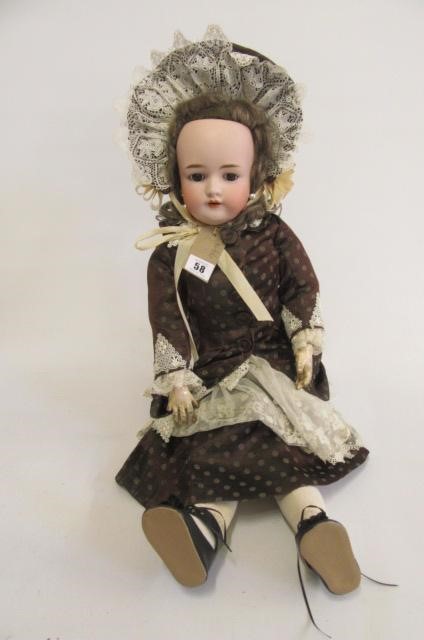 A Heinrich Handwerck bisque head doll with brown glass sleeping eyes Image