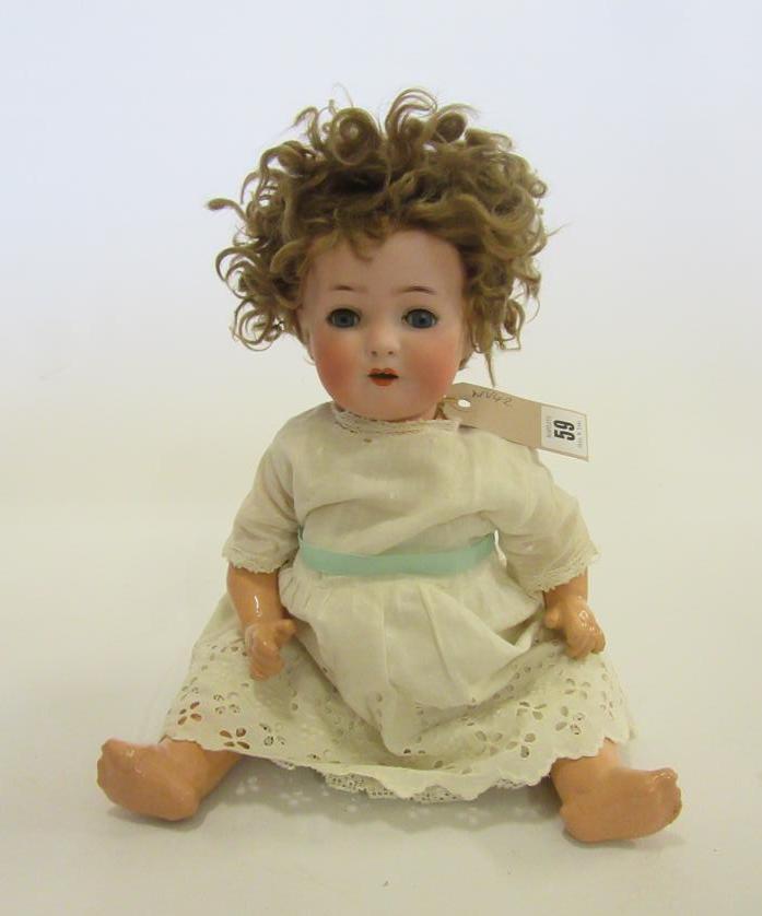 An Ernst Heubach bisque head doll with blue glass sleeping eyes Image