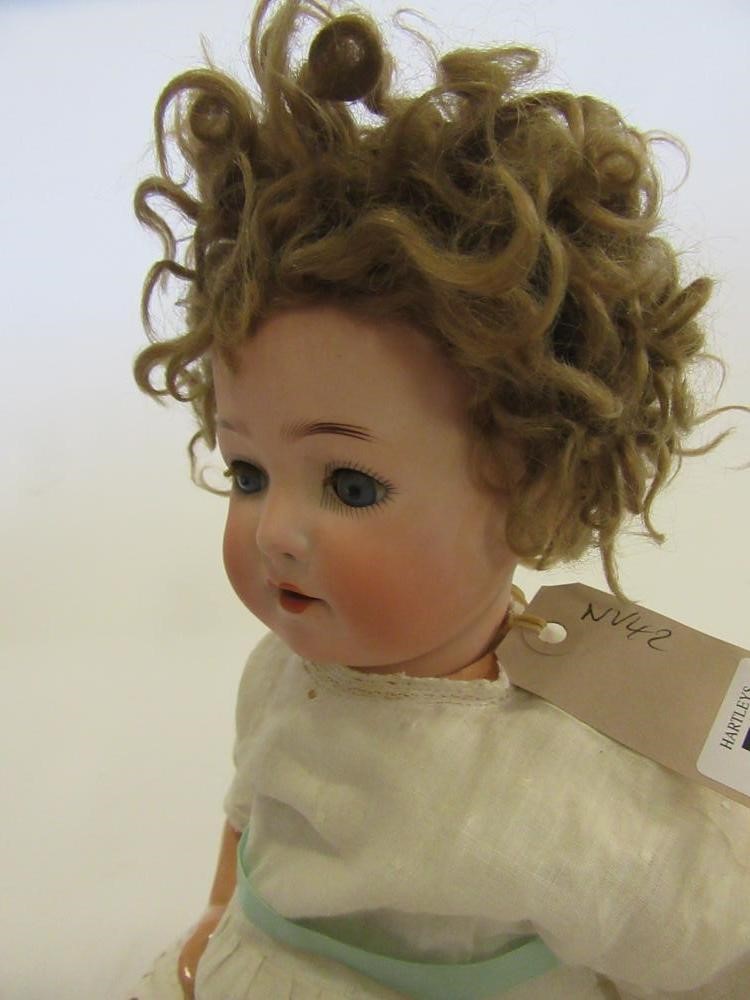 An Ernst Heubach bisque head doll with blue glass sleeping eyes Image