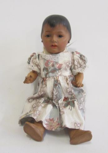 An Ernst Heubach bisque head mulatto doll with brown glass sleeping eyes Image