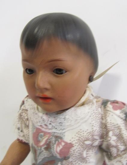 An Ernst Heubach bisque head mulatto doll with brown glass sleeping eyes Image