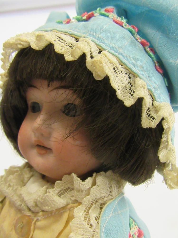 A Gebruder Knoch bisque head doll with fixed blue glass eyes Image