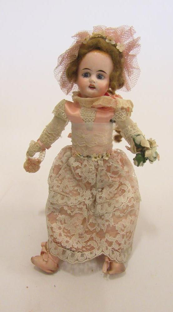A Sonneberger Porcellanfabrik bisque head doll with fixed blue glass eyes Image
